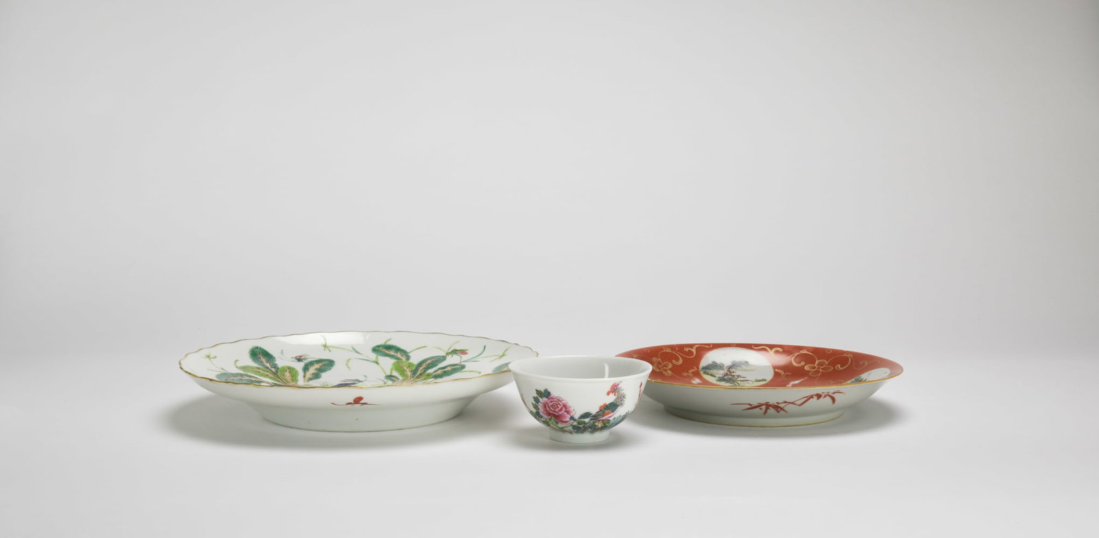 A Gilt-Red Glazed Ground Famille Rose Plate And Famile Glaze ‘Vegetable’ Plate, And Small Bowl,: A Gilt-Red Glazed Ground Famille Rose Plate And Famile Glaze ‘Vegetable’ Plate, And Small Bowl, Late Qing ‘Da Qing Qanglong Nian Zhi, Da Qing Guangxu Nian Zhi, Daoguang Nian Zhi̵