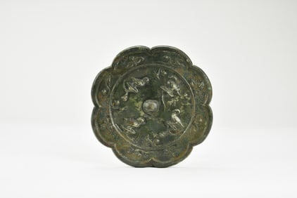 A Chinese Bronze Octafoil Mirror with Birds and Foliage, Tang Dynasty (618–907).