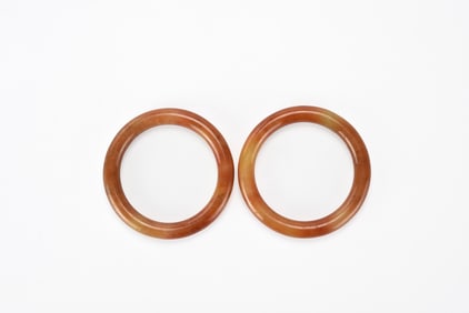 A Pair of Reddish Jadeite Bangles