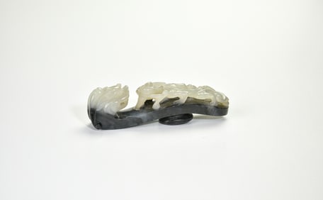 A Two-Tone Jade ‘Dragon and Chilong’ Belt Hook, Qing Dynasty.