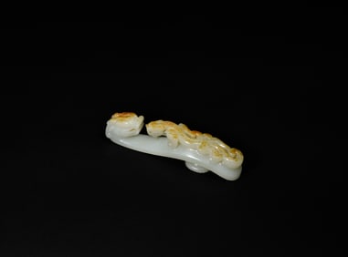 A Finely Carved White Jade Belt Hook with Russet Inclusions and Chilong Design, Qianlong Period