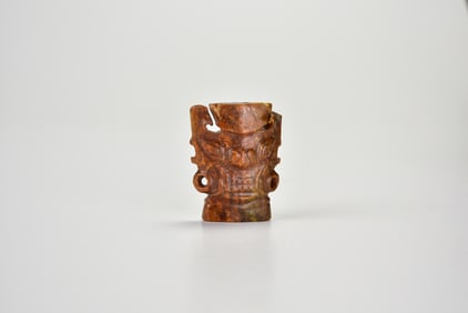 A Brown Jade Ornament Carved with a Divine Mask, Shijiahe Culture, ca. 2500–2000 BC.