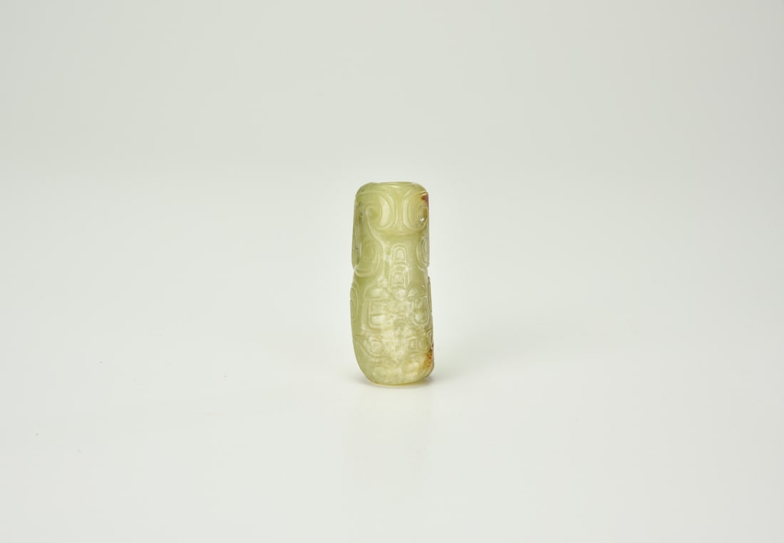 A Celadon And Russet Jade Cylindrical Bead (Cong-Form)Han Dynasty (206 Bce – 220 Ce): A Celadon And Russet Jade Cylindrical Bead (Cong-Form)Han Dynasty (206 Bce – 220 Ce)Of cylindrical form, the jade is well hollowed through the center and decorated on the exterior with shallowly