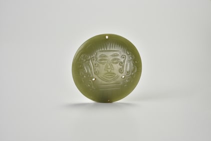 A Rare Archaic Celadon Jade Circular Plaque Carved with a Shamanic Mask, Shijiahe Culture, ca.