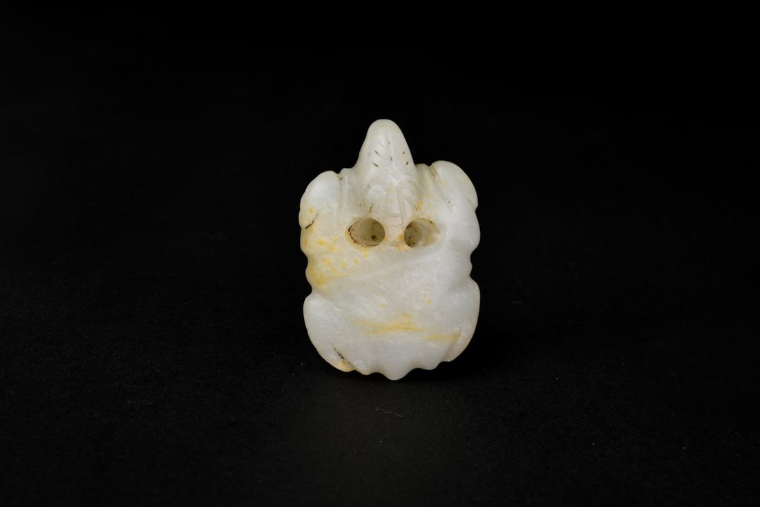 A Celadon Jade Turtle, Shang Dynasty (circa 13th–11th Century BC): A Celadon Jade Turtle, Shang Dynasty (circa 13th–11th Century BC)Carved from a fine piece of translucent celadon jade, the figure depicts a turtle with a domed shell, tucked limbs, and a slightl