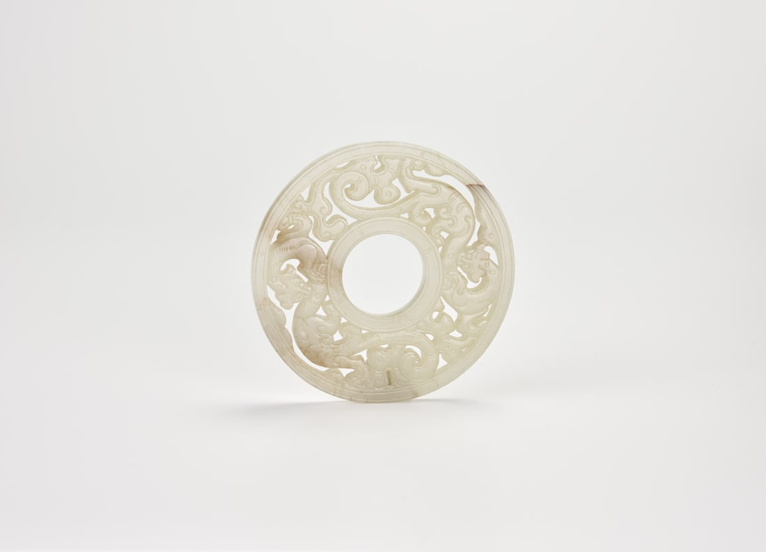 A Fine Celadon Jade “Bi?? Disc with Two Chilong Dragons, Western Han Dynasty (circa 2nd Century: A Fine Celadon Jade “Bi” Disc with Two Chilong Dragons, Western Han Dynasty (circa 2nd Century BC)Carved in openwork from a single piece of translucent celadon jCarved in openwork with two