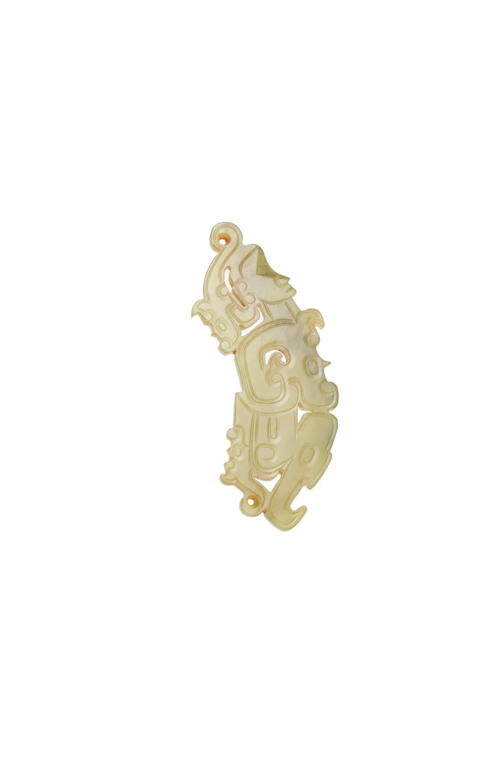 A Pale Celadon Jade Openwork Dragon Pendant, Han Dynasty (206 Bce – 220 Ce): A Pale Celadon Jade Openwork Dragon Pendant, Han Dynasty (206 Bce – 220 Ce) Carved in openwork as a sinuous dragon with the head turned back toward the body, the form defined by scrolls and circ