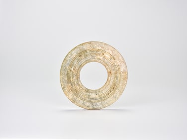 A Jade Ring with Concentric Grooves, Shang Dynasty (circa 1600–1046 BC) Carved from a mottled