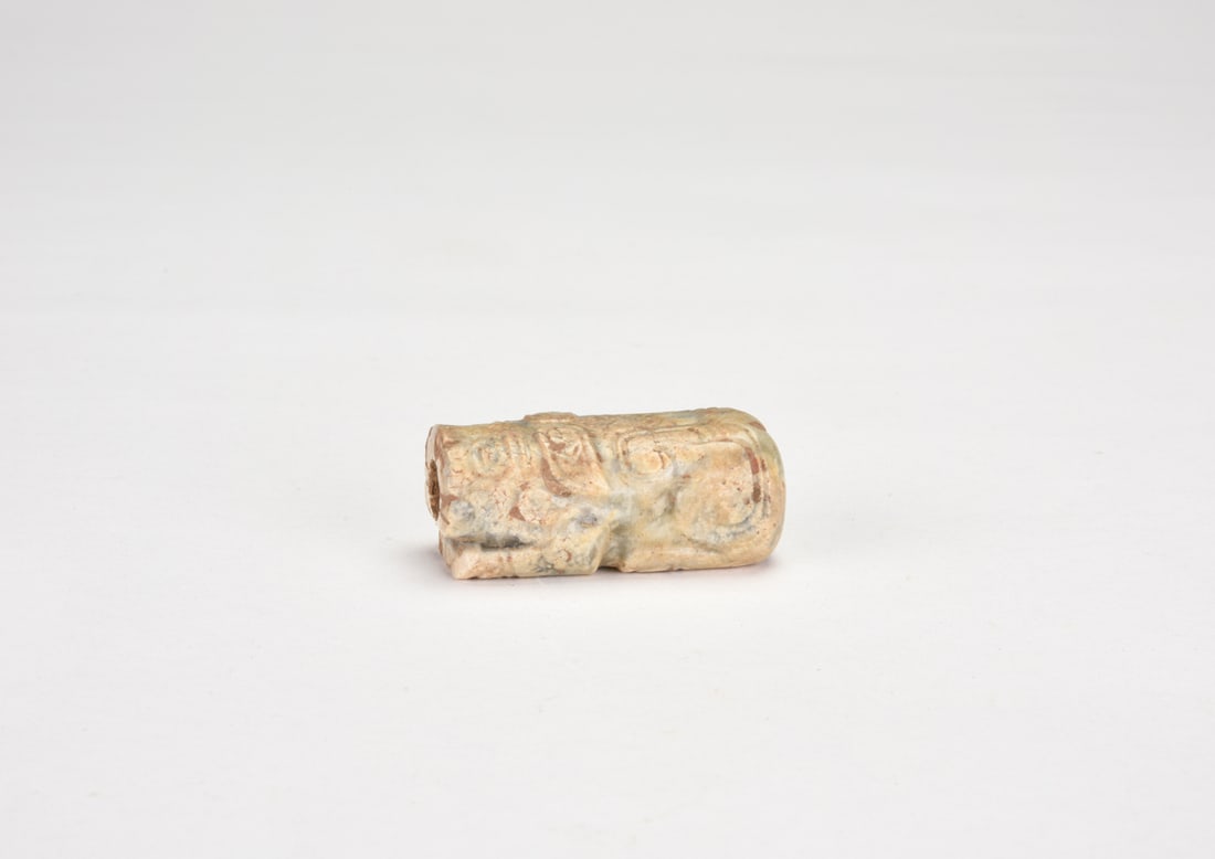 Shang Dynasty Jade Ox. Shang Dynasty, Circa 1600–1046 Bc.: Carved in the round, the ox standing with lowered head and compact body. The horns short and inward-curving, the limbs simplified. Incised lines define the eyes and contours. The stone of greyish-whit