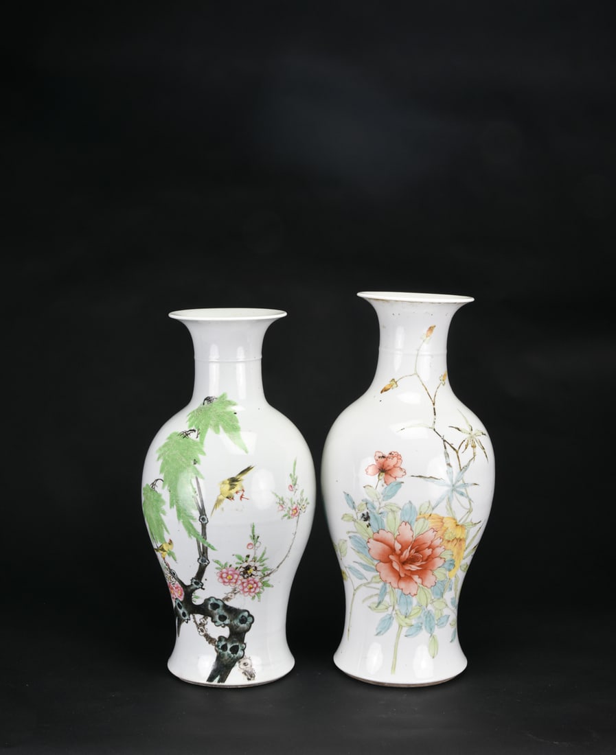Republic Period (Circa 1928) - A Two Qianjiang-style Enamel Vases with Floral and Bird Decoration: One vase is decorated with flowering branches, prominently featuring peonies rendered in delicate pink and green tones, with a bird depicted near the neck. The companion vase depicts birds among pine 