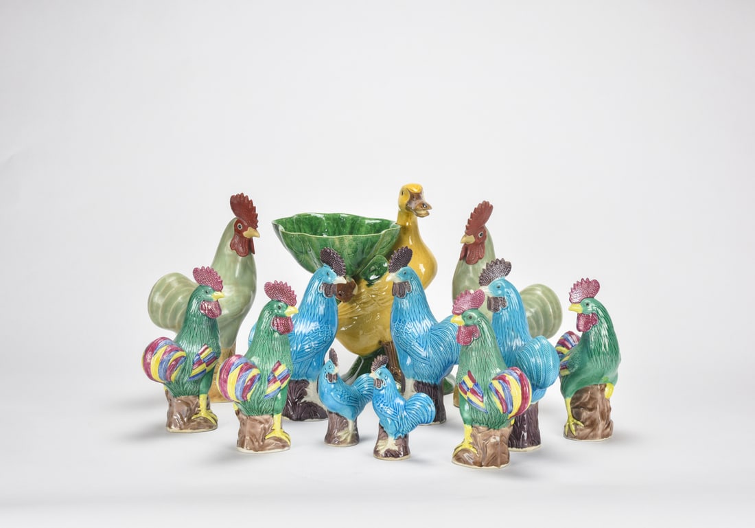 A Group of Twelve Polychrome-Glazed Bird Figures 20th Century: The figures are vividly modelled with finely detailed plumage and brightly coloured glazes. Several are shown standing on tree-stump bases in varied poses, enhancing their decorative appeal. Suitable 