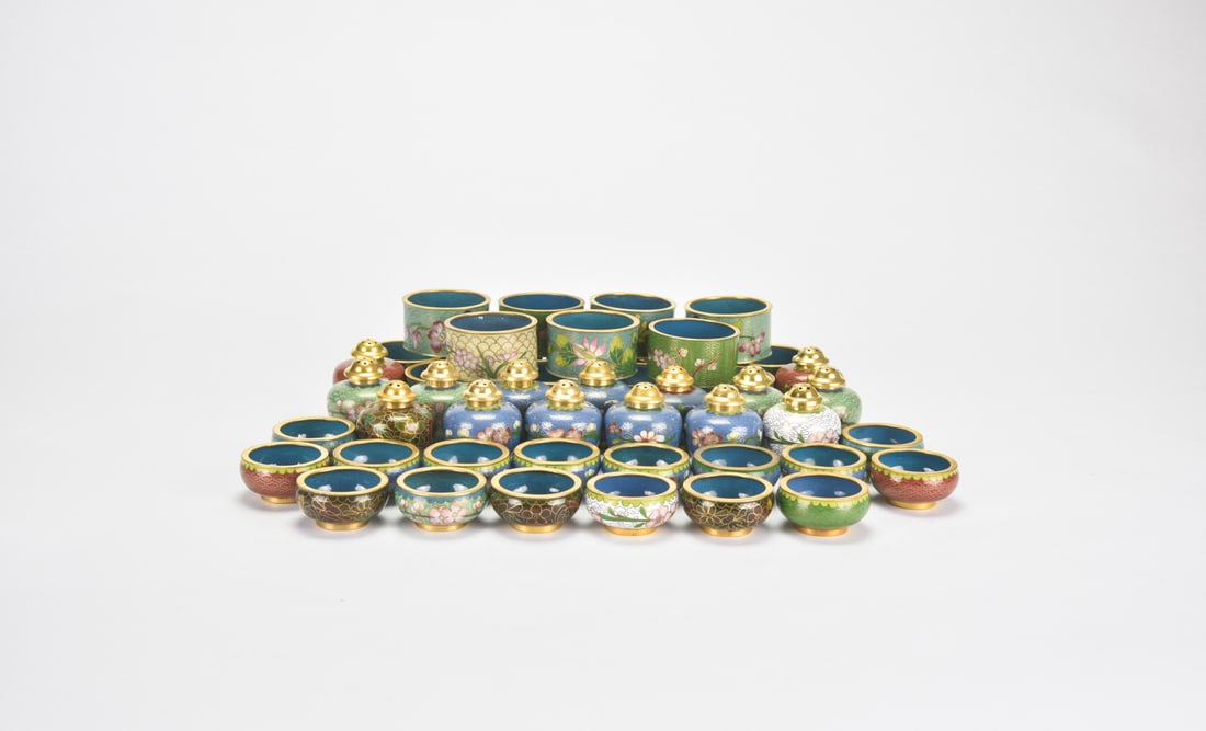 Forty-Eight Cloisonn? Enamel Tablewares: Including 16 wine cups, 16 salt shakers, and 16 napkin holders, decorated with floral motifs reserved on turquoise and polychrome grounds. The wine cups are of cylindrical form with gilt rims and inte