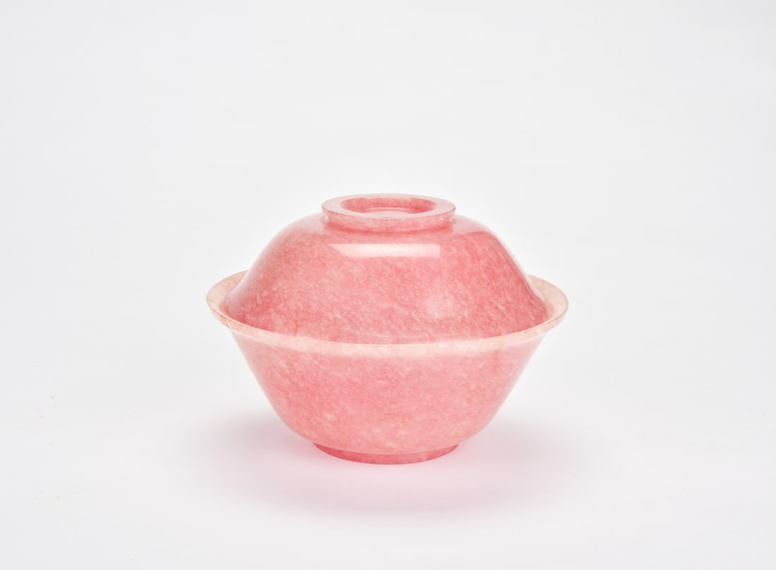 A Pink Hardstone Covered Bowl, Possibly Calcite: Carved from a mottled pink hardstone of rounded form, comprising a domed cover and a matching deep bowl with gently flared rim. The stone displays variegated tones ranging from pale rose to deeper pin