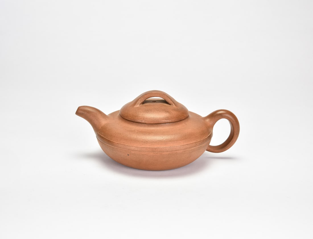 A Yixing Stoneware Teapot: Signed Dasheng Of compressed globular form, the vessel rising from a slightly recessed base to a broad shoulder and short curved spout, set opposite a circular loop handle. The domed cover surmounted 