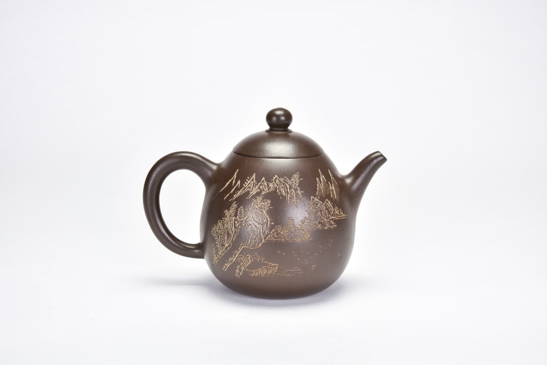 A Yixing Stoneware Teapot: Ren Ganting Of rounded compressed form with gently tapering sides, set with branch-form spout and handle modeled in imitation of natural wood, the domed cover surmounted by a sculpted prunus branch