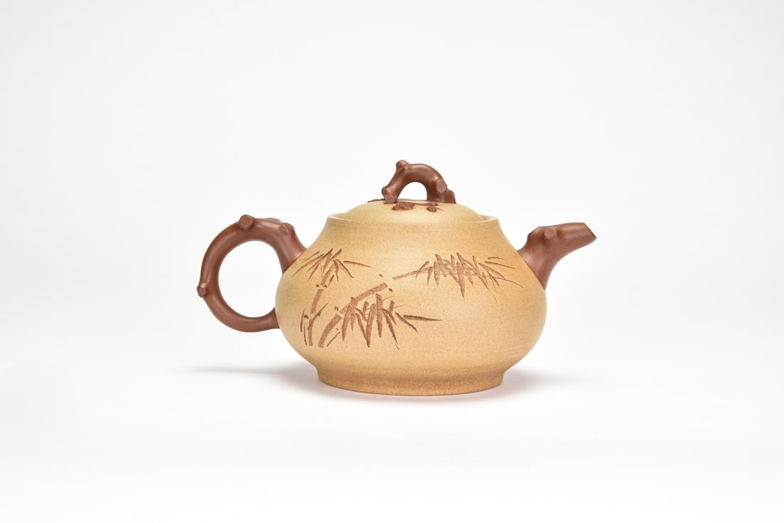 A Yixing Stoneware Teapot: Signed Yao Zhiyuan Of globular form with a gently swelling body, set with a domed cover surmounted by a spherical knop. One side finely incised with a mountainous river landscape in the literati