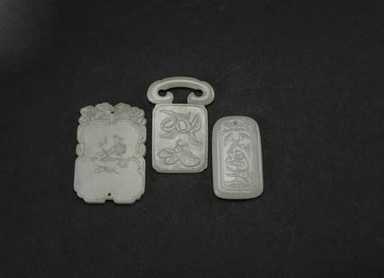 Qing-A group of three white jade pendants: Qing A group of three white jade pendants 6.2 x 4.2 x 0.5 cm. (2 3/8 x 1 5/8 x 3/16 in.) 清 白玉牌一組三件