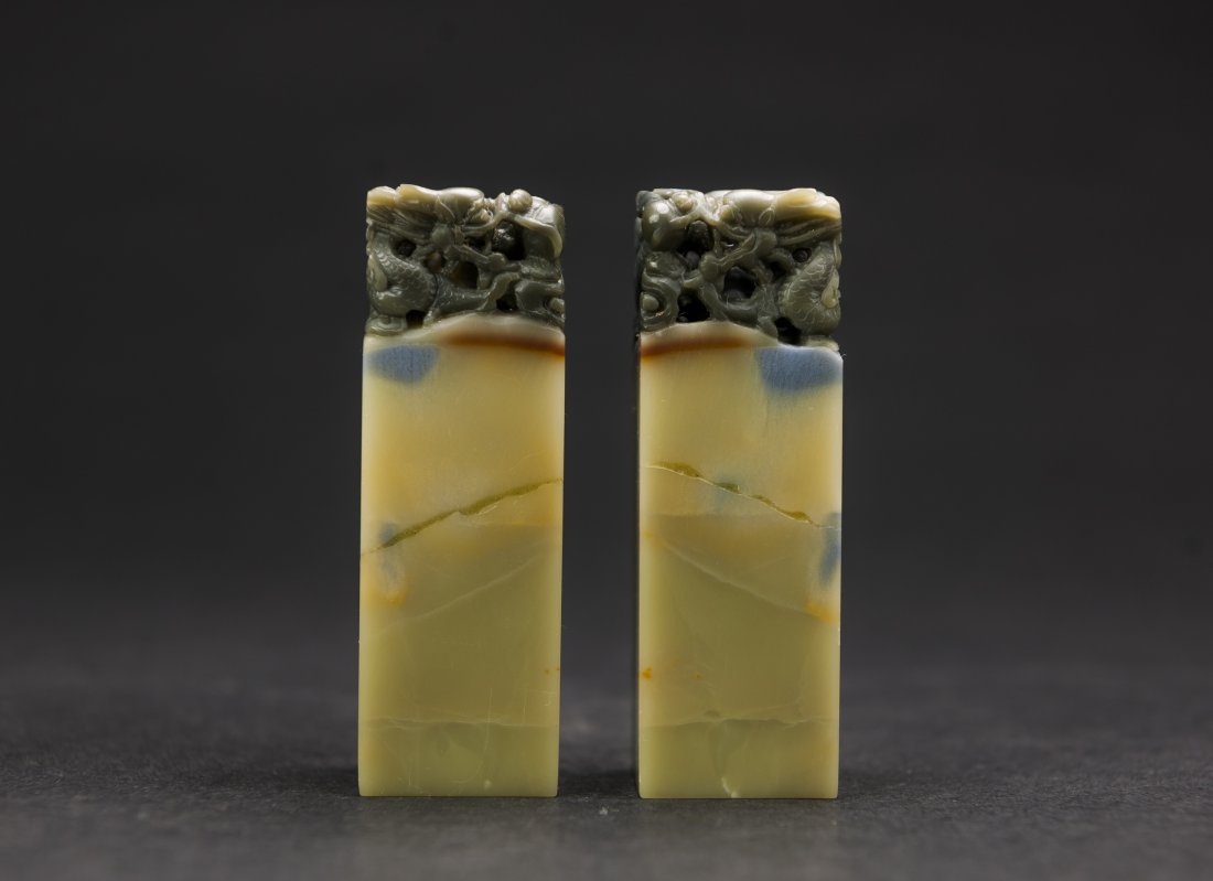 A soapstone carved dragon seal: A soapstone carved dragon seal 2.5 x 2.5 x 8.2 cm. (1 x 1 x 3 1/4 in.) 青田石龍鈕印章一對