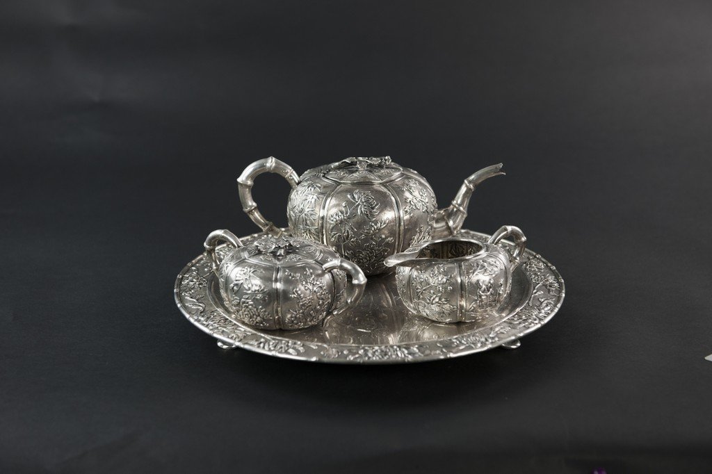 Late Qing/ Republic - A SET OF CHINESE SILVER TEA SET: Late Qing/ Republic A SET OF CHINESE SILVER TEA SET (4 Pieces) Silver Tray: 33.5 cm. (13 1/4 in.); (Shanghai, XX 記，UFUWI ) Mark Tea Pot: 24 cm. Sugar Jag : 15.5 cm. Milk Jag :14 cm. 