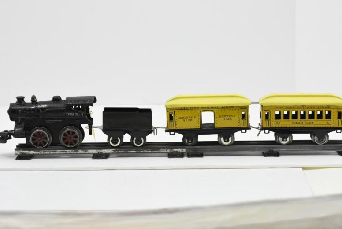 Ives Wind Up Train with (3) cars: Ives wind up train one side says no. 0 and the other says no.5(6"L x 3.25"H x 2.5"W) comes with one repro tender, one original baggage car, and one chair car