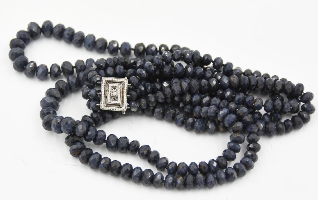 3 strand natural sapphire necklace by Daum French Lines: Handstrung bead necklace. Dark blue rondel beaded necklace. Three strand gemstones with art deco style push open silver clasp and cubic zirconia. Elegant, classic and trendy all at once. 11"Drop. Ston