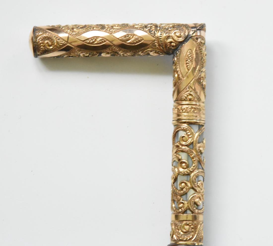 14K Gold Plated Cane with Mother of Pearl Antique: Gold plated with Mother of Pearl inlay ebony wood shaft. 36 1/2" L