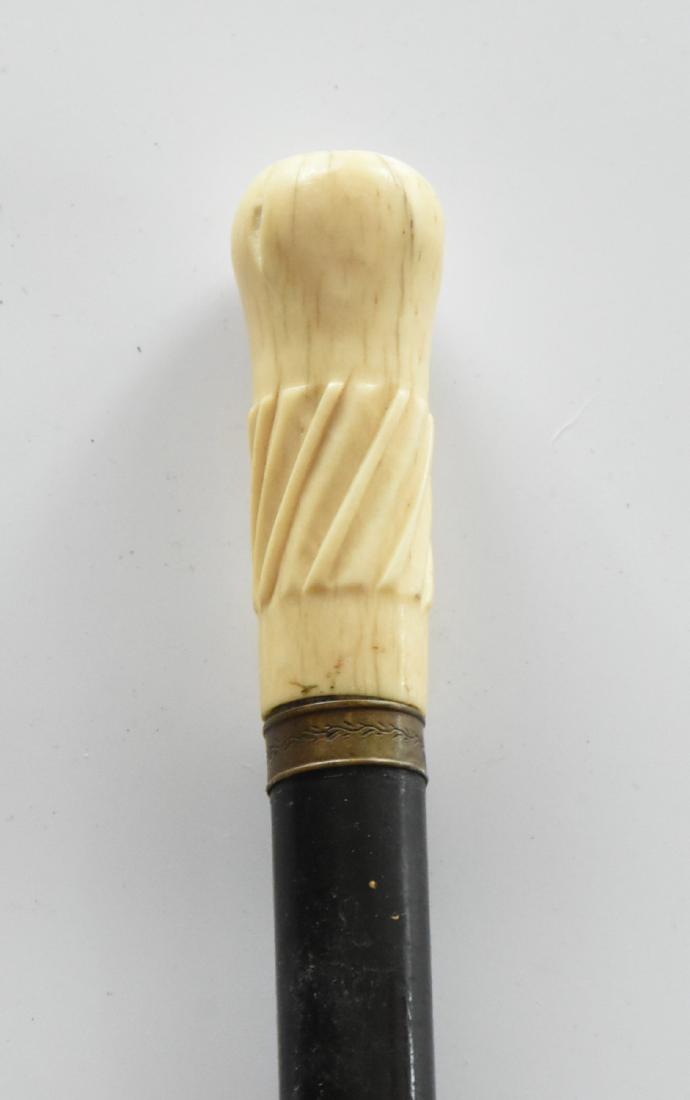 Carved Bone Handle Cane Copper Ring Vintage: Carved bone knob on a vintage cane. The Copper ring has a design on it. 35"L