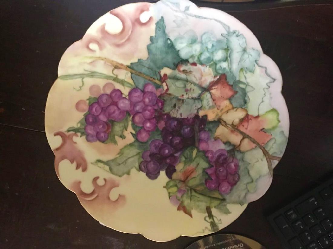 19TH CENTURY LARGE LIMOGES HAND PAINTED CHARGER: Designed in a grape motif. Signed to back by the artist. Dated 1899. Measures 13-1/2" in diameter. Third party shipping required. Local recommendations will be provided on final invoice.