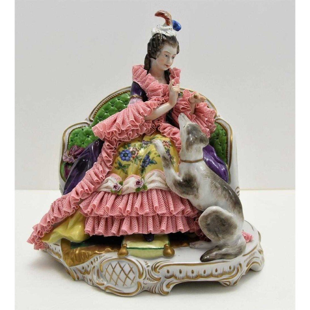 Dresden German Woman & Her Dog Companion: Porcelain Woman giving a treats w/ her dog companion Beautiful attention to detail on this piece. 9.5H x 8.5W x 6.5"D