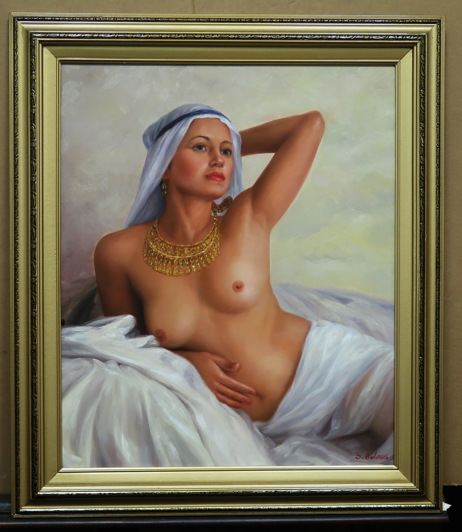 By S. Belous Blue-Eyed Haram Woman Oil on Canvas: A nude woman lies her breasts revealed wears an tassel gold necklace and white ghuttra head scarf indicating purity, signed by the artist below right corner. Painting size: 24" x 20"; w/ frame: 29" x 