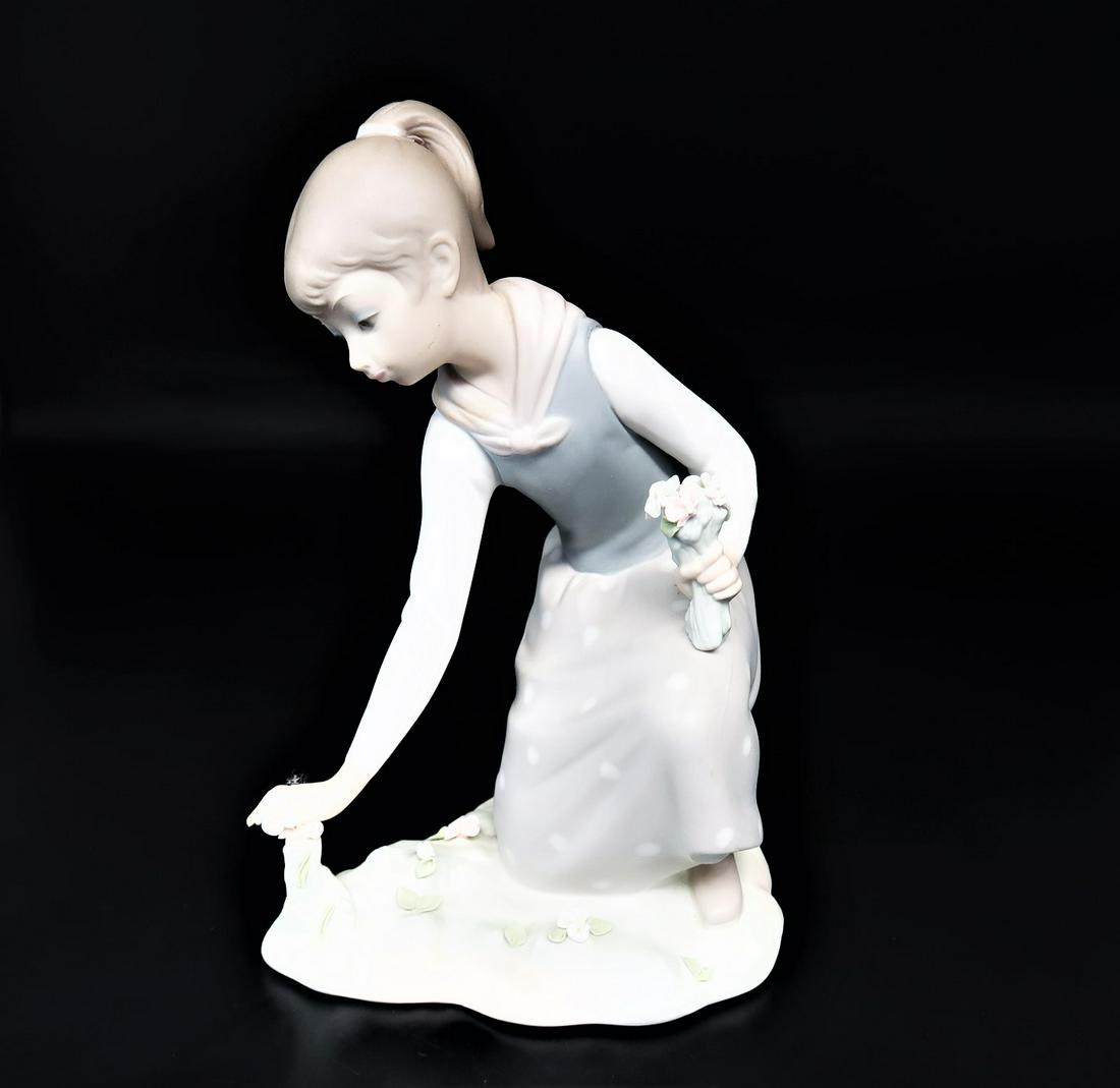by LLadro "Picking Flowers": LLadro "Picking Flowers" with stamp on thebottom. Size; 7 1/2" x 5 1/2" x 3 1/2". Hand made in Spain