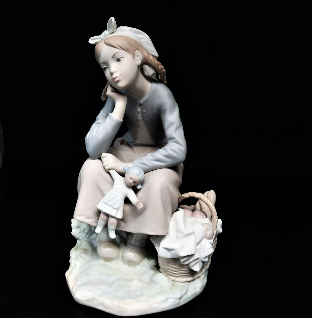 by LLadro "Thinking" Girl w/ Doll and Bread Basket: LLadro "Thinking" Girl w/ Doll and Bread Basket with stamp on the bottom. Size: 8 1/2" x 5" x 3 1/2". Hand made in Spain