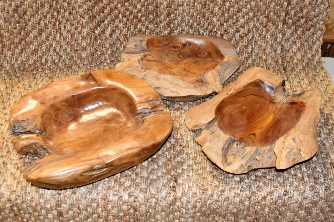 Three teak wooden bowls: Three teak wooden bowls. Sizes range from 6 inches high to 18 inches by 18 inches, 19 by 18, 19 by 15.