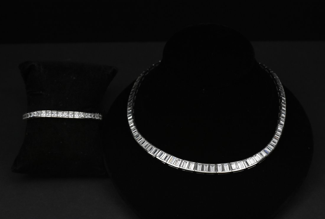 set of chrystal in silver bracelet and chrystal in: necklace 18" bracelet 7" 925 sterling silver and crystal emerald cut, every 2 stones are hinged .75K stones average, 94 stones on the necklace. The Bracelet is 925 sterling silver with .5K crystal, 43