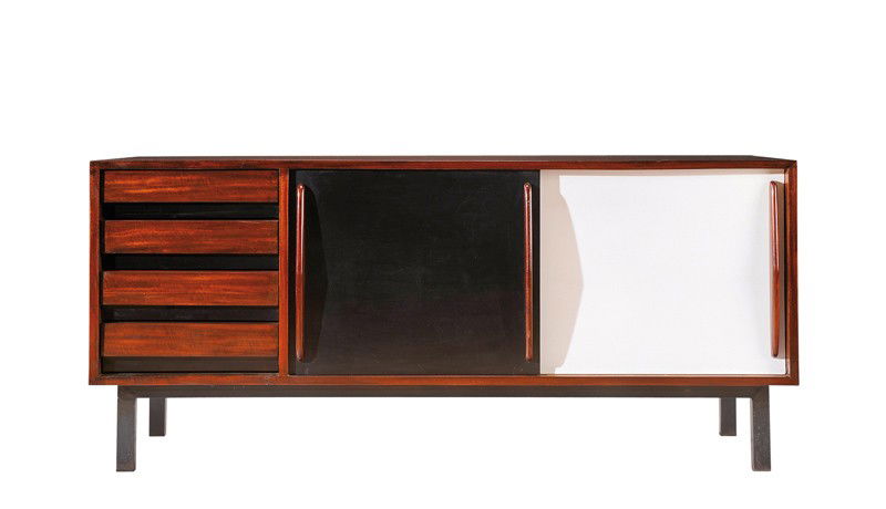 CHARLOTTE PERIAND (1903-1999)Edited by Steph Simon: A tinted mahogany veneer sideboard opening by two black and white formica sliding doors. Circa 1958. 28 in. (71 cm) high, 62 in. (158 cm) length, 17 3/4 in. (45 cm) depth Provenance : City of Cansado