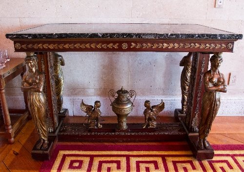 Empire Style Ormolu-mounted mahogany table: Empire Style Ormolu-mounted mahogany table in the manner of Jacob Desmalter. Featuring a rectangular verde antico marble top with a frieze of laurel leaves on ormolu female caryatid supports. An H-sha