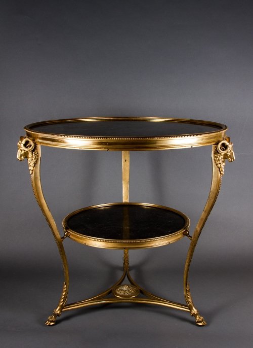 Pair of French gilt Gueridon Tables, Paris, late 20th c: Pair of French gilt Gueridon Tables, Paris, late 20th century Gilted bronze with black marble decorated with rams’ heads and cabriole legs 27.5 x 27.5 x 27.25 in. - 70 x 70 x 69 cm. Provenance Sothe