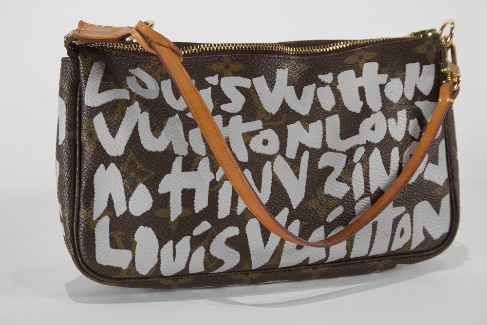Louis Vuitton: Limited Edition Monogram Graffiti by Stephen Sprouse White Accessory Pouch with Honey Patina on the Leather Strap 9” Width x 11” Height x 1” Depth Excellent Condition