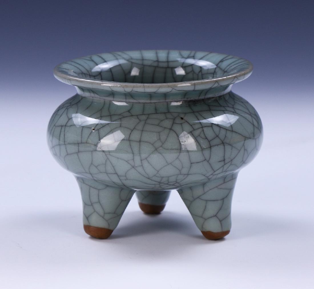 A CHINESE ANTIQUE GUAN-STYLE TRI-POD PORCELAIN CENSER: A Chinese Antique Guan-Style Tri-Pod Porcelain Censer: Thickly Potted, The Compressed Globular Body Supported On Three Feet, With Short Wide Neck Rising To Broadly Flared Mouth, Applied Overall With A
