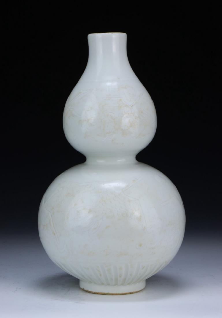 A CHINESE ANTIQUE WHITE GLAZED PORCELAIN VASE: A Chinese Antique White Glazed Porcelain Vase: Of Gourd Form With An All Over White Glaze; Size: H: 10" (25.4cm)