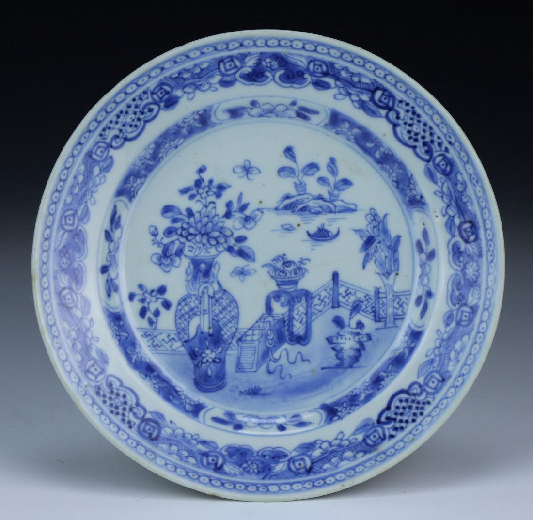 A CHINESE ANTIQUE BLUE & WHITE PORCELAIN PLATE: A Chinese Antique Blue & White Porcelain Plate: The interior Finely Painted With A Garden Scene Surrounded By Floral Motifs Around The Rim, Of Middle Qing Dynasty; Size: D: 6-1/2" (16.51cm)