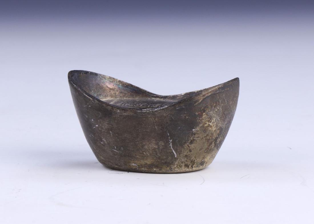 A CHINESE ANTIQUE SILVER NUGGET: A Chinese Antique Silver Nugget: Finely Carved With inscriptions On The Top And Base, Weighing Approximately 178. 89 Grams; Size: L: 2" (5.08cm); Weight: 178.89 Grams