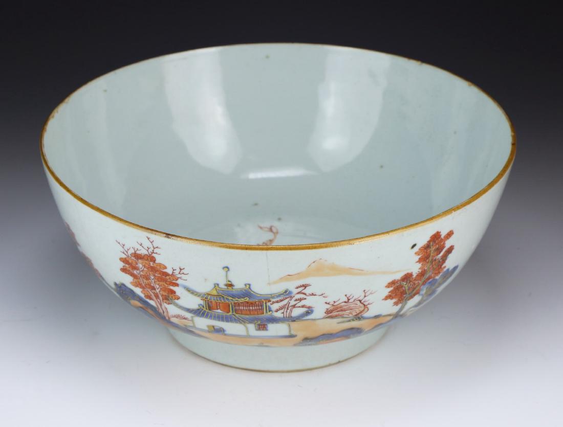 A CHINESE ANTIQUE FAMILLE ROSE PORCELAIN BOWL: A Chinese Antique Famille Rose Porcelain Bowl: Well Potted With Rounded Sides, Exterior Finely Painted With A Continuous Village Scene, interior Base Painted With A Sprouting Blossom, Early To Middle