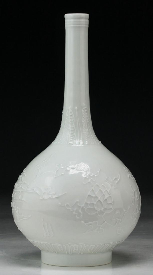 A CHINESE ANTIQUE WHITE GLAZED PORCELAIN VASE: A Chinese Antique White Glazed Porcelain Vase: Of Globular Form, Slim And Cylindrical Neck Rising To A Slightly Flared Rim, Body With A Ridged Finish in A Phoenix Shape; Size: H: 8" (20.32cm)