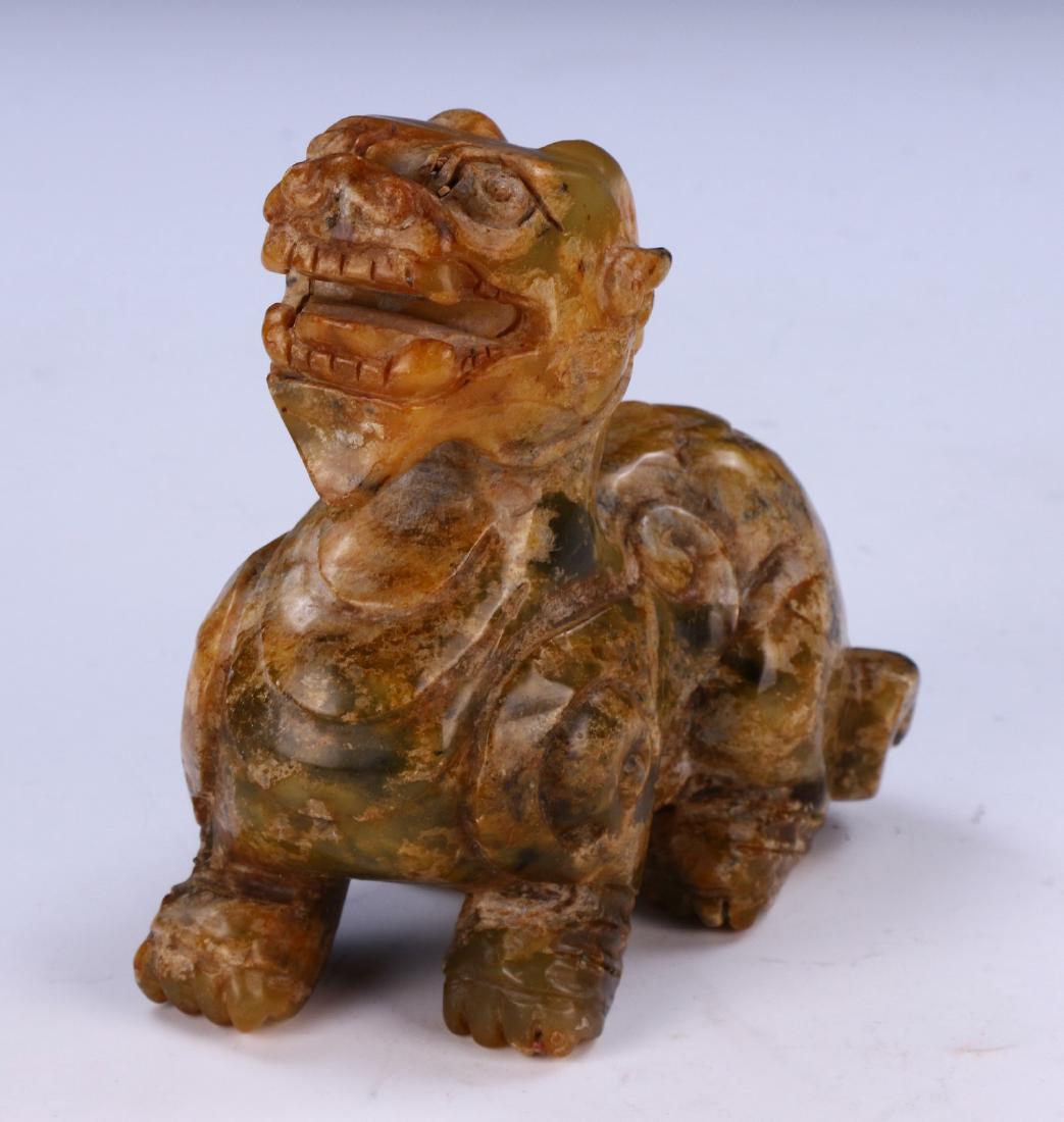 A CHINESE ANTIQUE CARVED STONE PIXIU: A Chinese Antique Carved Stone Pixiu: Finely Carved And Shown On All Fours, Head Reared Back, Teeth Bared, Chest Puffed Out; Size: H: 5-1/4" (13.34cm)