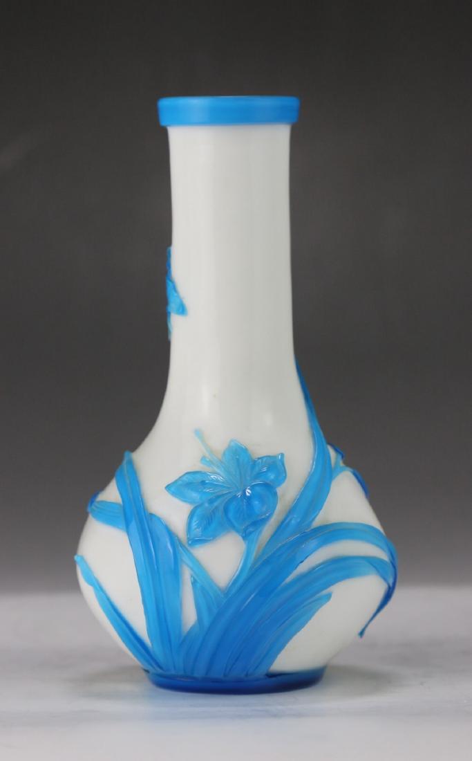 A CHINESE ANTIQUE PEKING GLASS VASE: A Chinese Antique Peking Glass Vase: Of Globular Form Rising To A Cylindrical Neck, With Blue Flowers And Branches Around The Body; Size: H: 7" (17.78cm)
