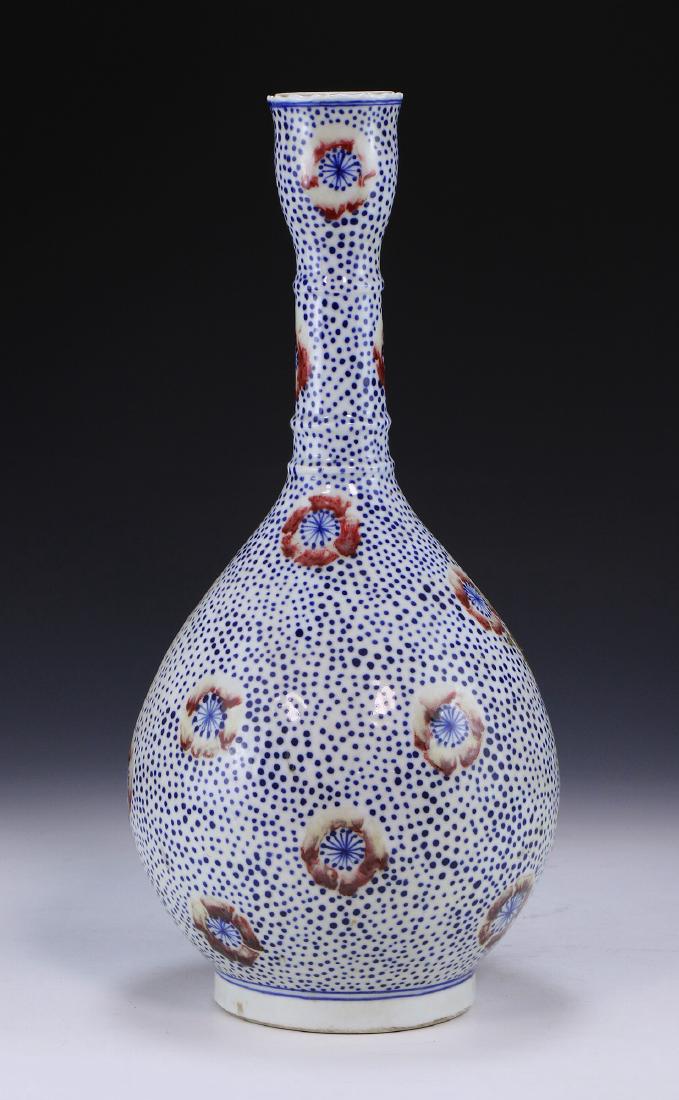 A CHINESE ANTIQUE FAMILLE ROSE VASE: A Chinese Antique Famille Rose Vase: Of Globular Form, With A Long And Skinny Neck, Leading To A Very Slightly Flared Rim, Finely Decorated With Tiny Blue Dots And Blooming Flowers Along The Body And