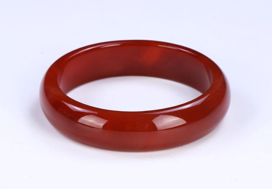 A RED JADE BANGLE (1 of 2)