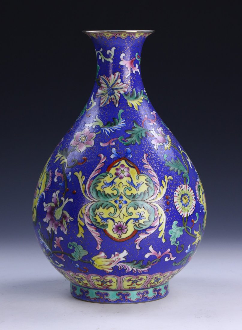 A CHINESE ANTIQUE FAMILLE ROSE PORCELAIN VASE: A Chinese Antique Famille Rose Porcelain Vase: Of Ovoid Form Rising To A Flared Rim, The Body Finely Painted With Blossoming Branches On A Blue Glazed Ground, The Base With A Six Character QIANLONG Ma