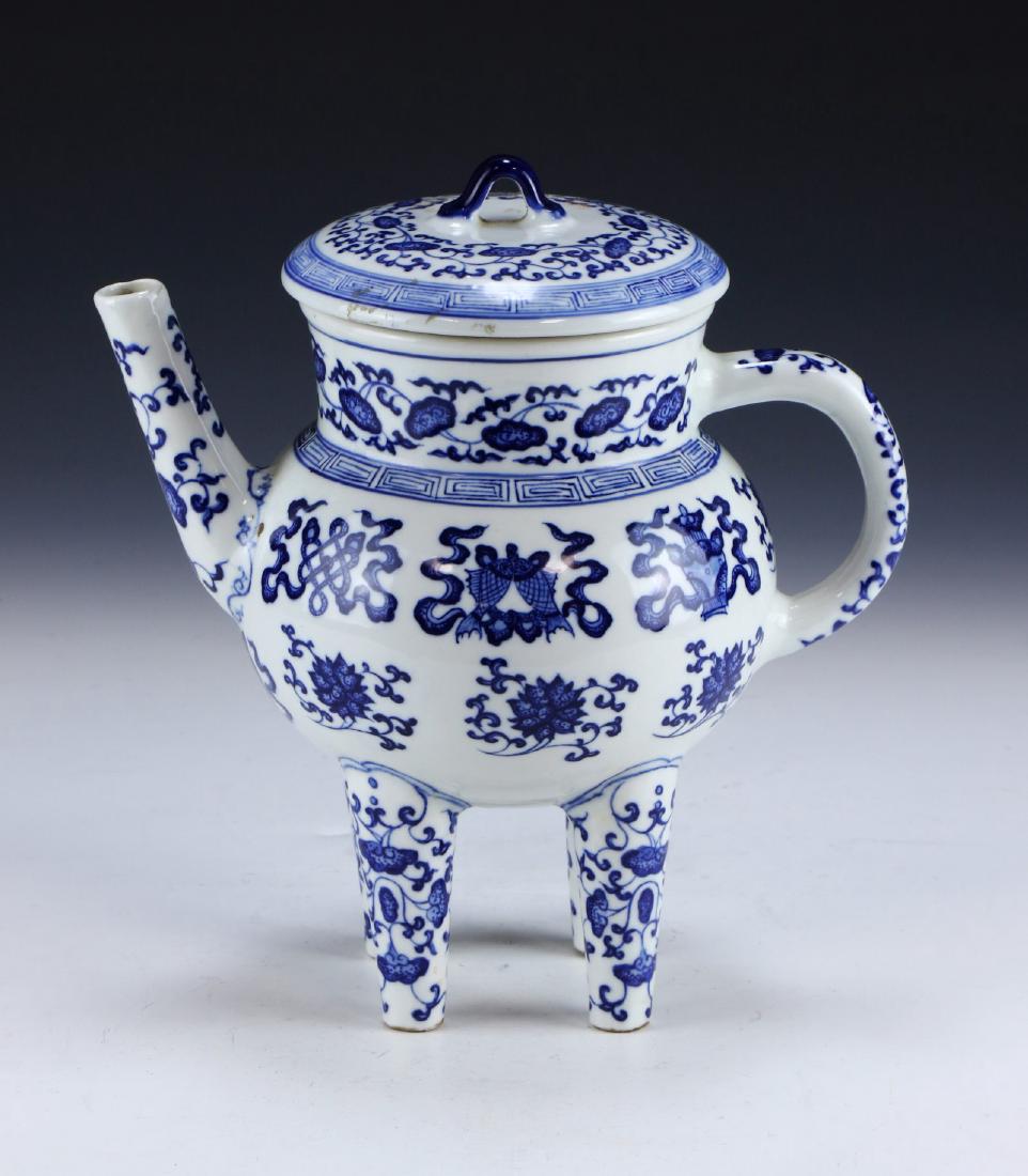 A CHINESE ANTIQUE BLUE & WHITE PORCELAIN LIDDED WINE: A Chinese Antique Blue & White Porcelain Lidded Wine Pot: Of Globular Form Standing On Four Legs With A C-Shaped Handle And Long Spout, The Body Finely Painted With Blooming Lotus Vines Amid Scholarly
